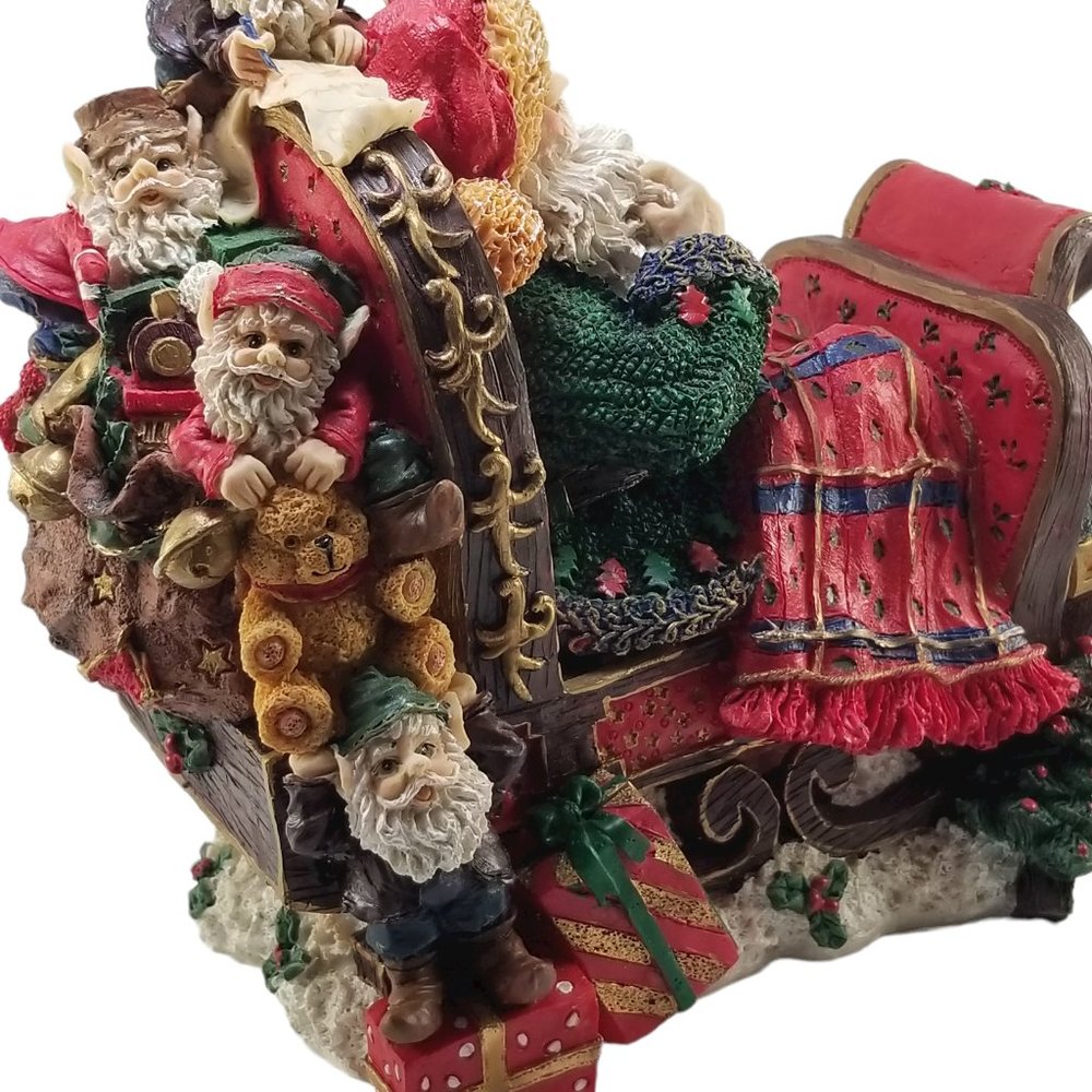 Santa in a Red Sleight Bed Resin Holiday Décor with Elves, Presents, And Toys - Picture 13 of 15